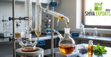 Close-up of a state-of-the-art fractional distillation apparatus, with thick borosilicate glass tubes, condensing amber liquids, precise digital temperature displays, clean modern chemistry lab environment