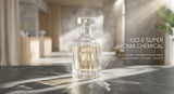 A minimalist, high-end photograph of a clear crystal decanter containing a light amber liquid, sitting on a polished dark grey concrete surface. Sunlight streams in, casting complex, ethereal light refractions and a soft, smoky aura around the bottle, symbolizing the radiant and transparent nature of ISO E SUPER. Soft, blurred background of a sophisticated, modern studio.