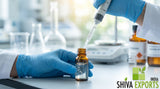 Close-up macro photograph of a chemist wearing nitrile gloves measuring clear aromatic fluid with a micro-pipette into an amber glass vial, laboratory background