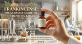 A hand holding a small bottle of frankincense essential oil, with a blurred background showing a laboratory setting with distillation equipment