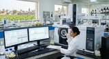 A modern laboratory setting in Kannauj, India, with a scientist analyzing a sample of jasmine absolute using GC-MS equipment. Focus on the scientific process and the advanced technology used.
