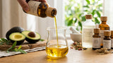 close-up shot of golden avocado oil being poured into a glass beaker, with fresh avocados and cosmetic bottles in the background, representing purity and natural beauty