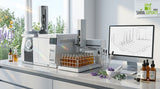 A clean modern laboratory bench with a gas chromatography mass spectrometer instrument and glass vials of golden plant extracts
